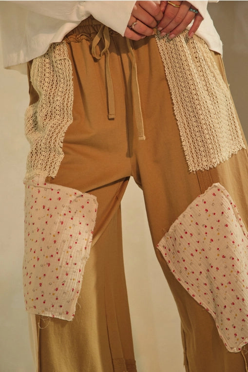 Wide-leg silhouette with relaxed fit
Drawstring waist for custom comfort
Mixed fabric patchwork with floral and knit textures
Lightweight and breathable cotton blend
Full-length hem, easy to style barefoot or with sneakers