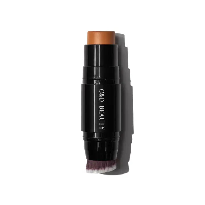 Makeup stick with brown top and black body on a white background
