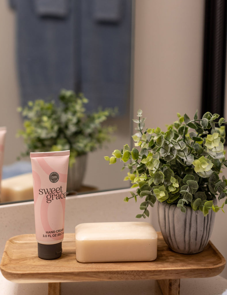 hand cream, soap and plant on wood stool