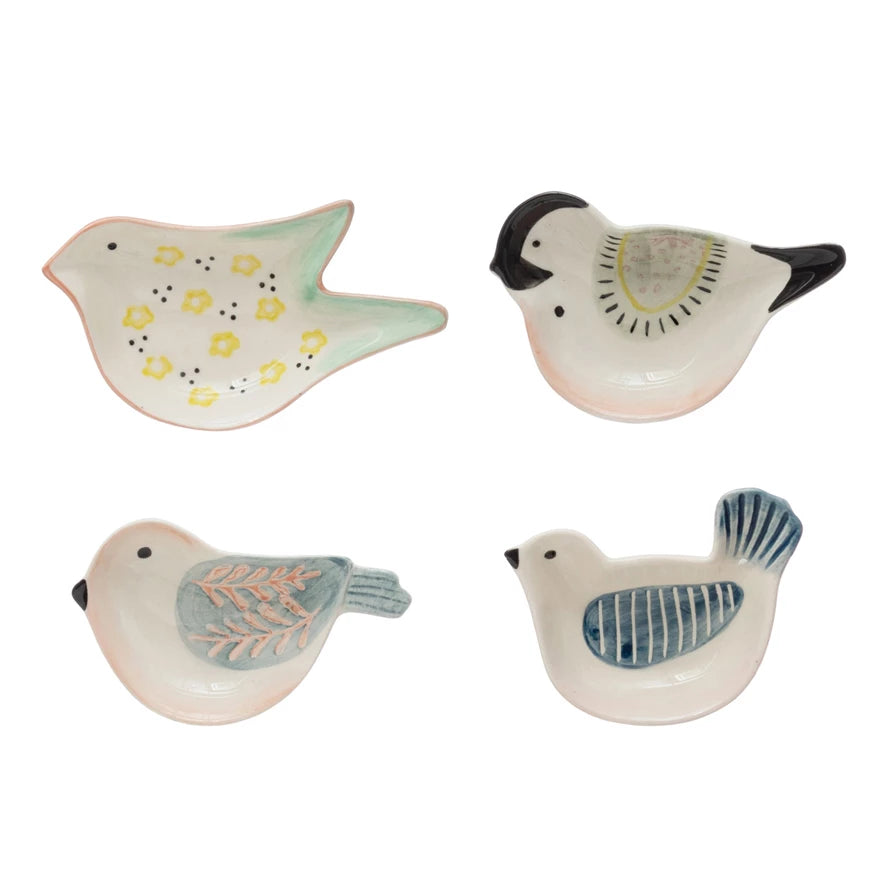 Four ceramic bird-shaped containers on a white background