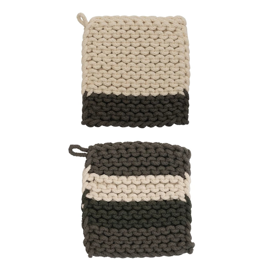 Two knitted potholders with a striped pattern on a white background