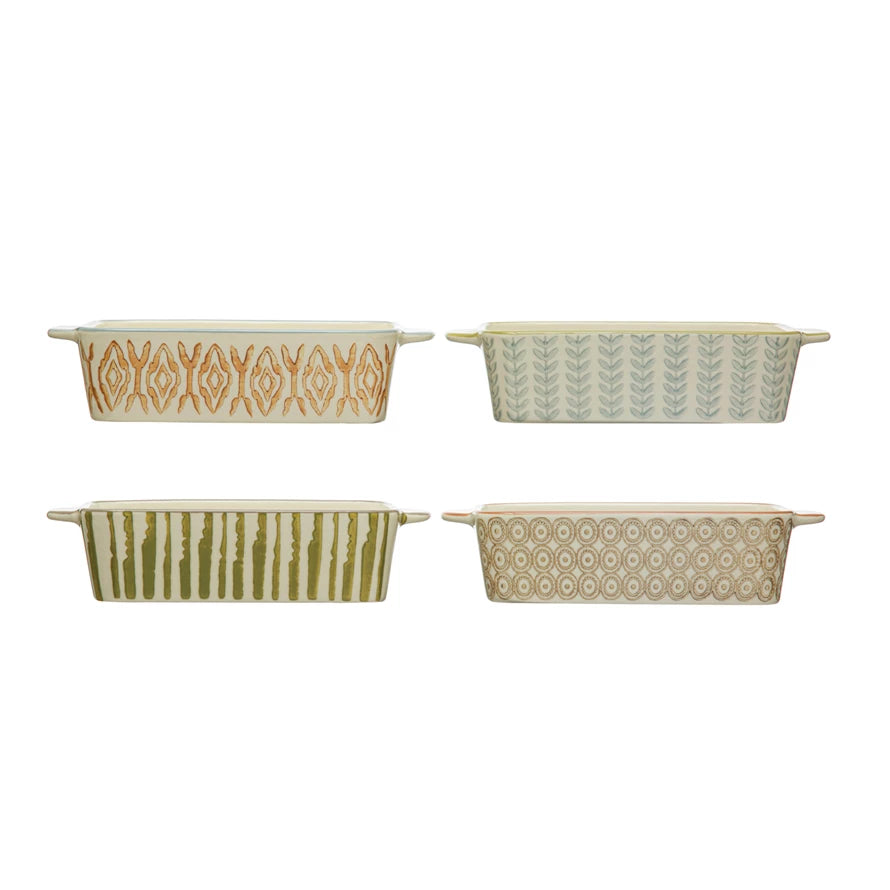 Four ceramic baking dishes with geometric patterns on a white background