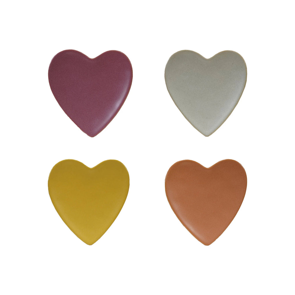 Four heart-shaped objects in different colors on a white background