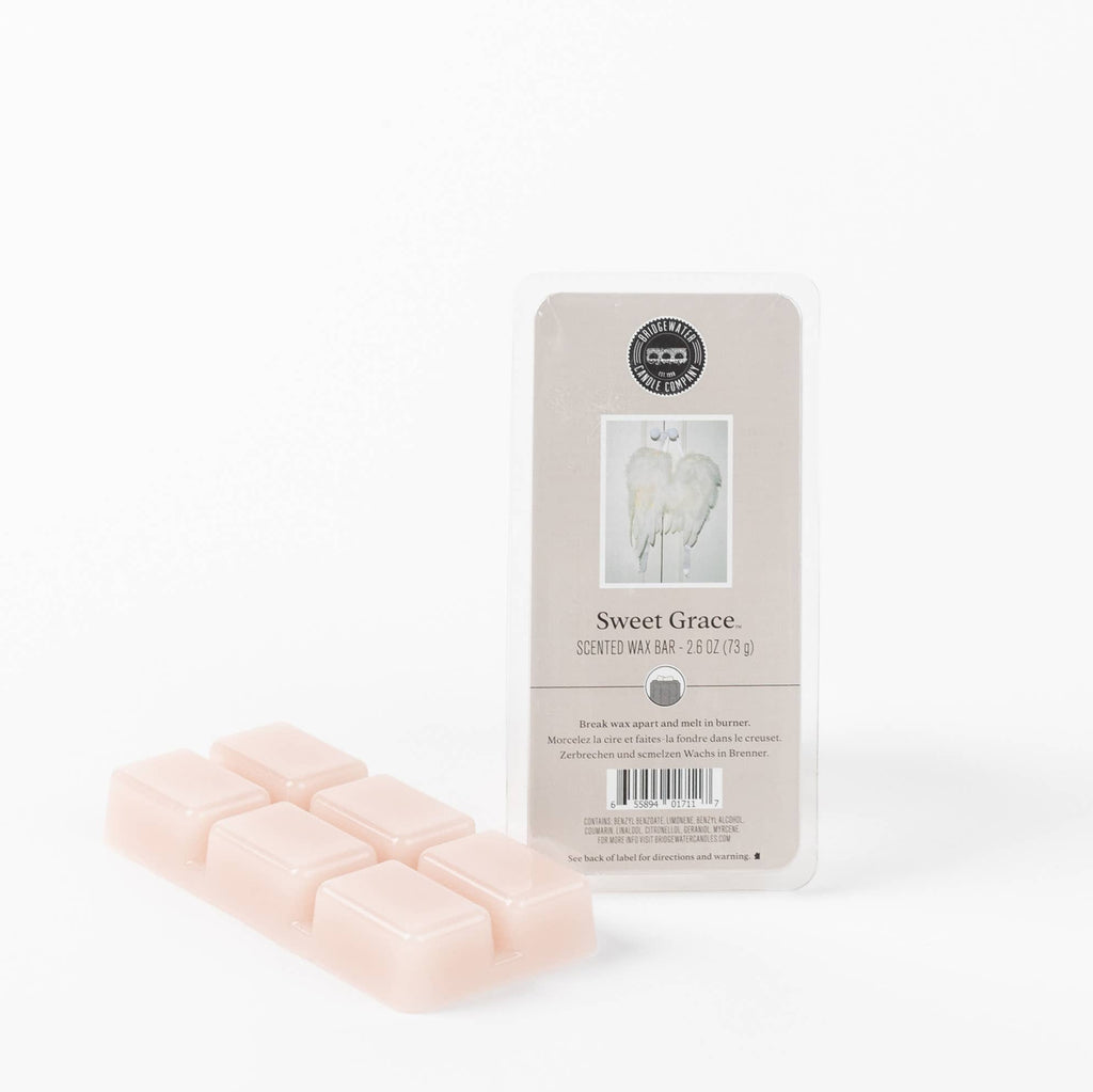 Set of pink wax bars with a 'Sweet Grace' packaging on a white background