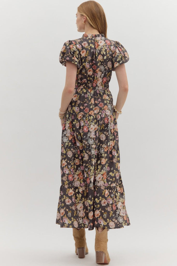 Woman wearing a floral dress with short sleeves on a white background