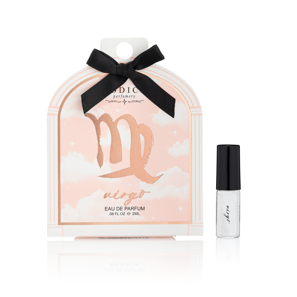 Perfume packaging with a black bow and a small bottle on a white background