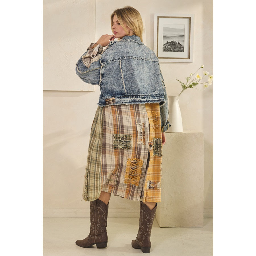 Woman wearing a denim jacket and plaid skirt indoors