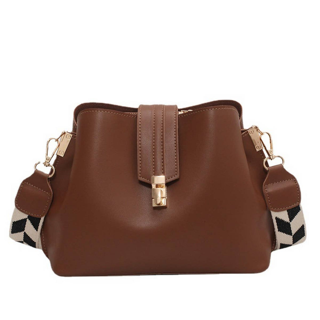 Brown handbag with a patterned strap on a white background