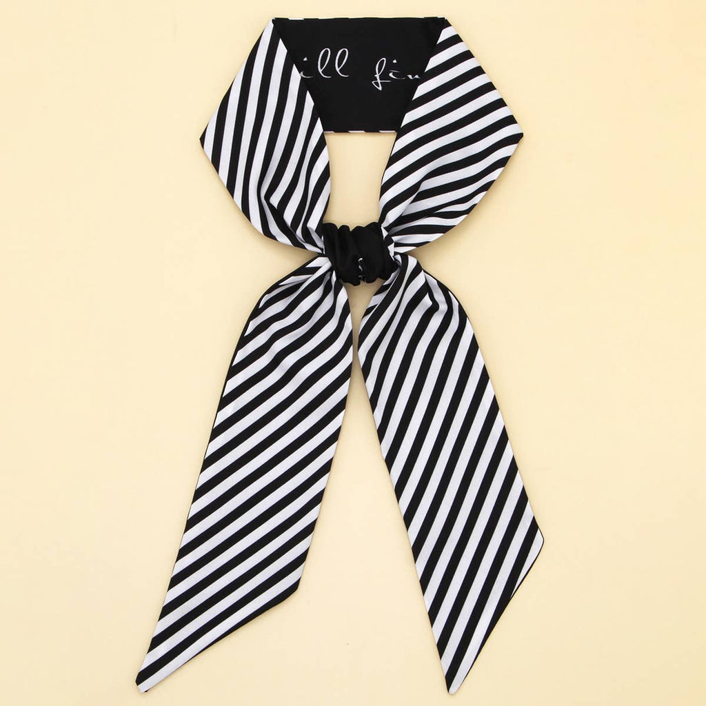 Black and white striped scarf with a knot on a beige background
