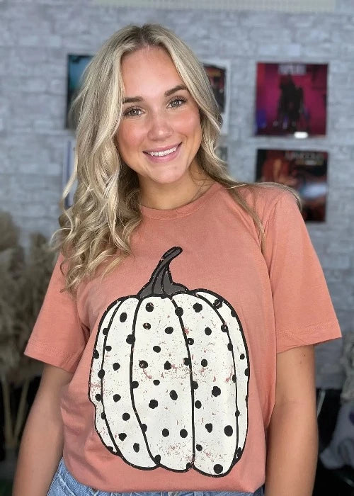 white pumpkin on terracotta tee on woman