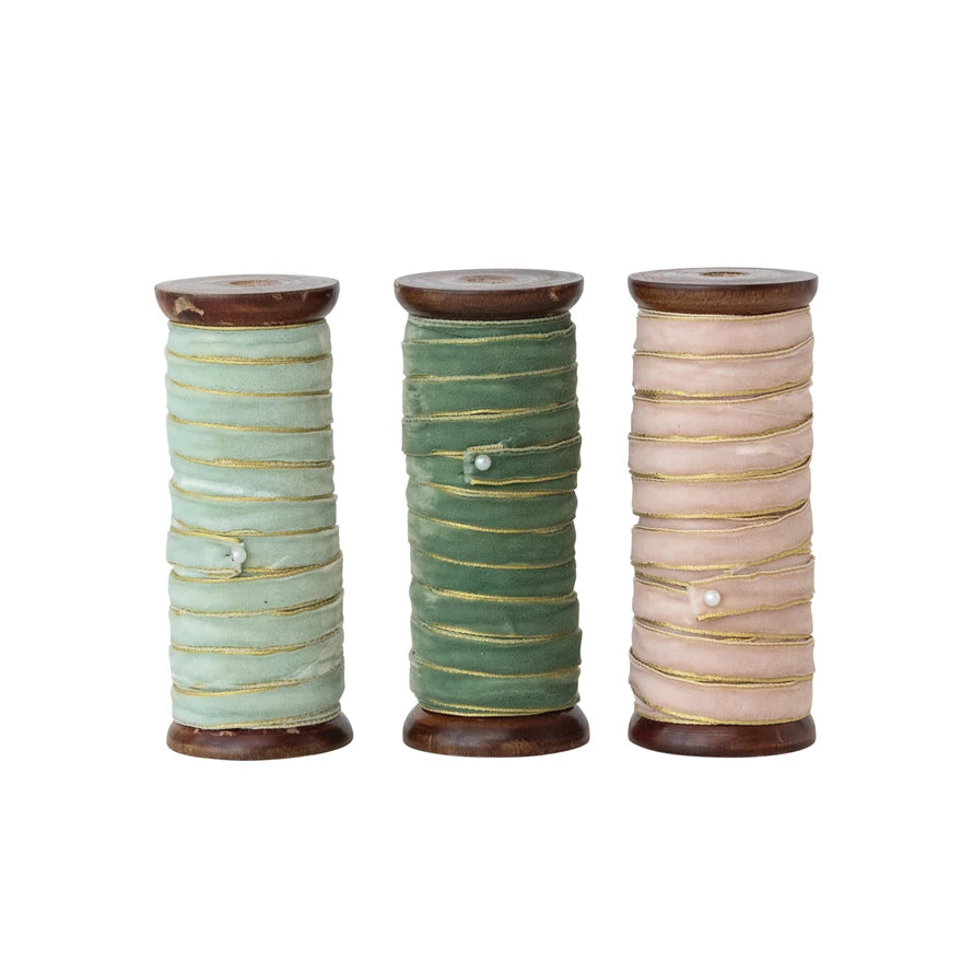 Three wood spools with velvet ribbon in blush, sage, and deep green, each with metallic gold edges, 10 yards long.