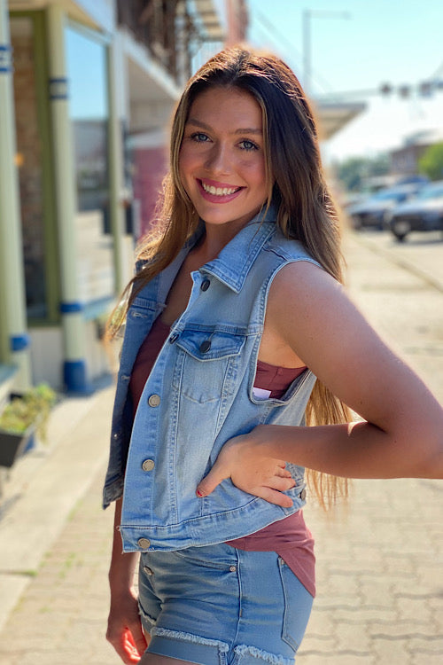 young woman wearing a boutique denim cropped vest  - side